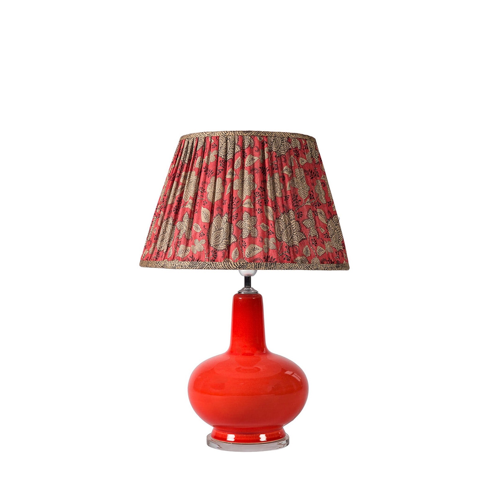Red lamp with a patterned shade on a white background
