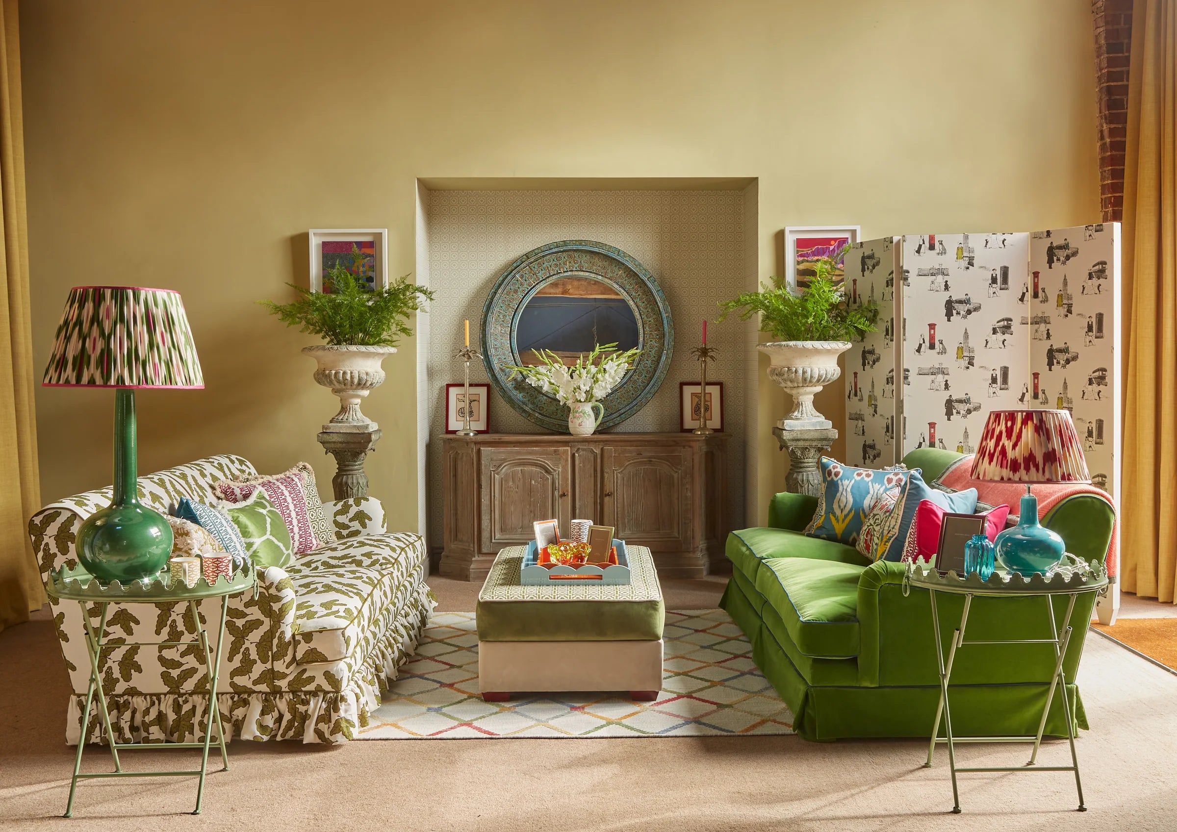 Living room with green sofa, patterned armchair, and decorative items.