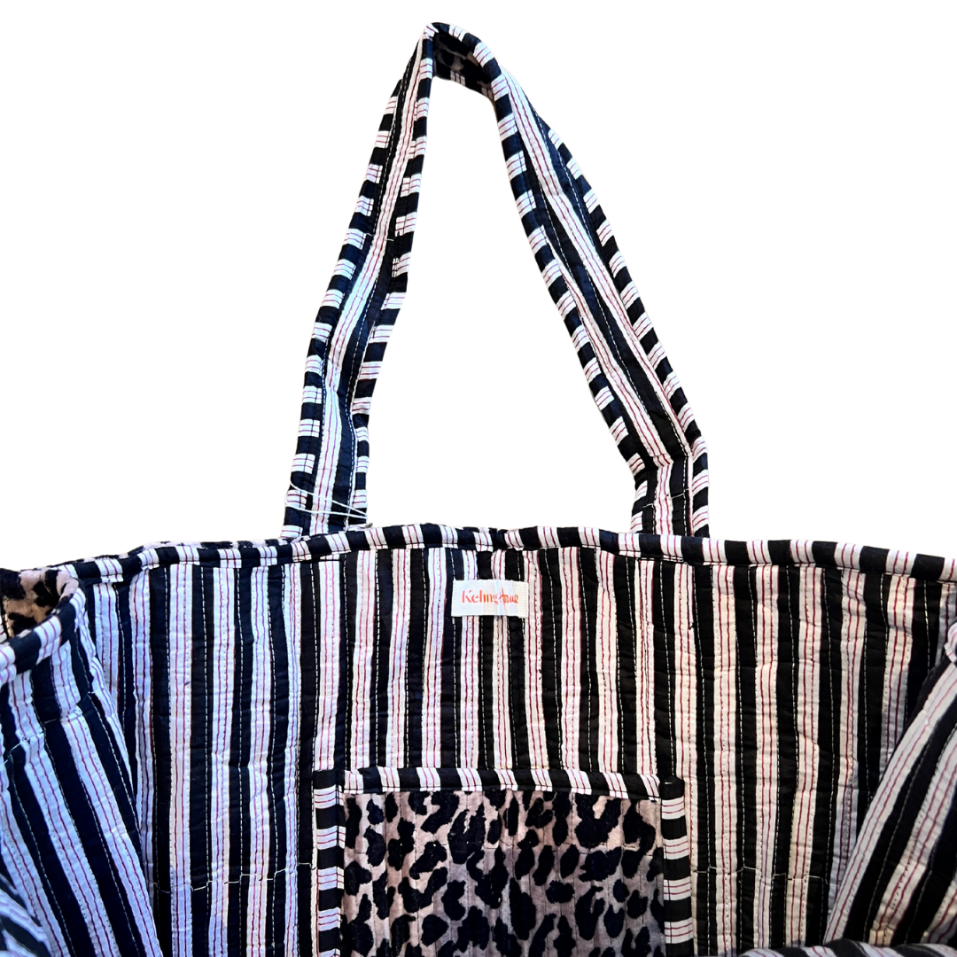 Striped tote bag with leopard print pocket on a white background
