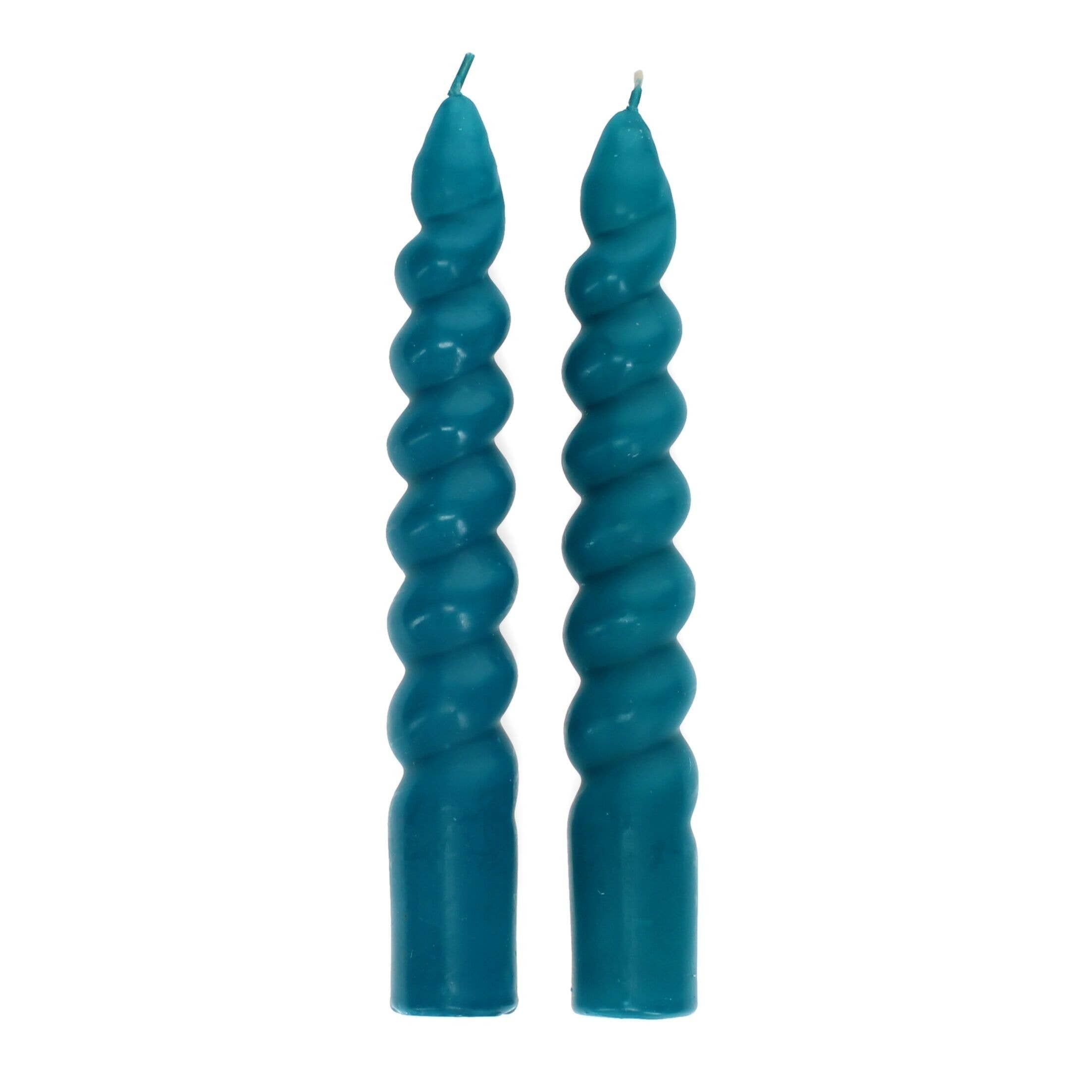 Two teal spiral candles on a white background