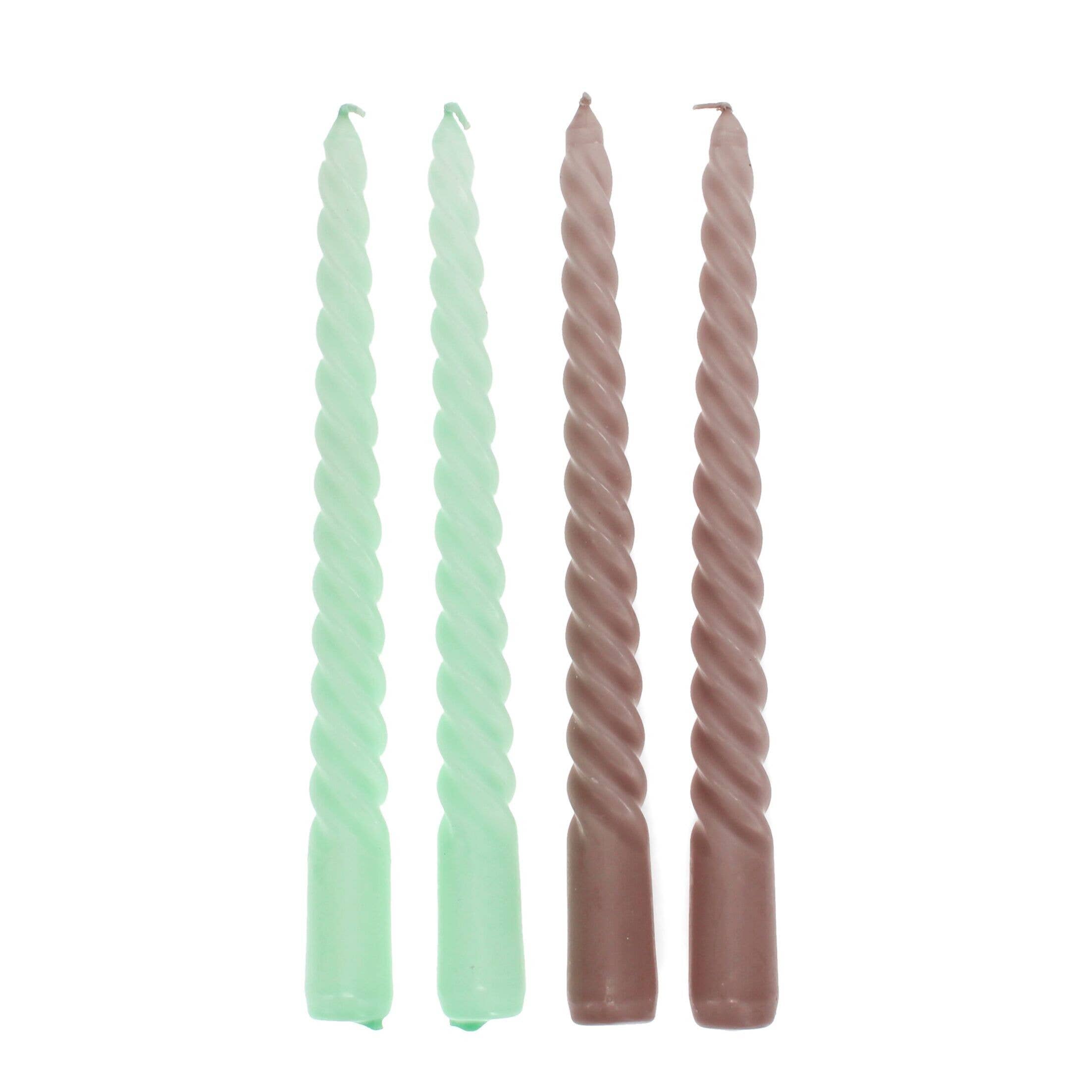 Two pairs of twisted candles, one green and one brown, on a white background