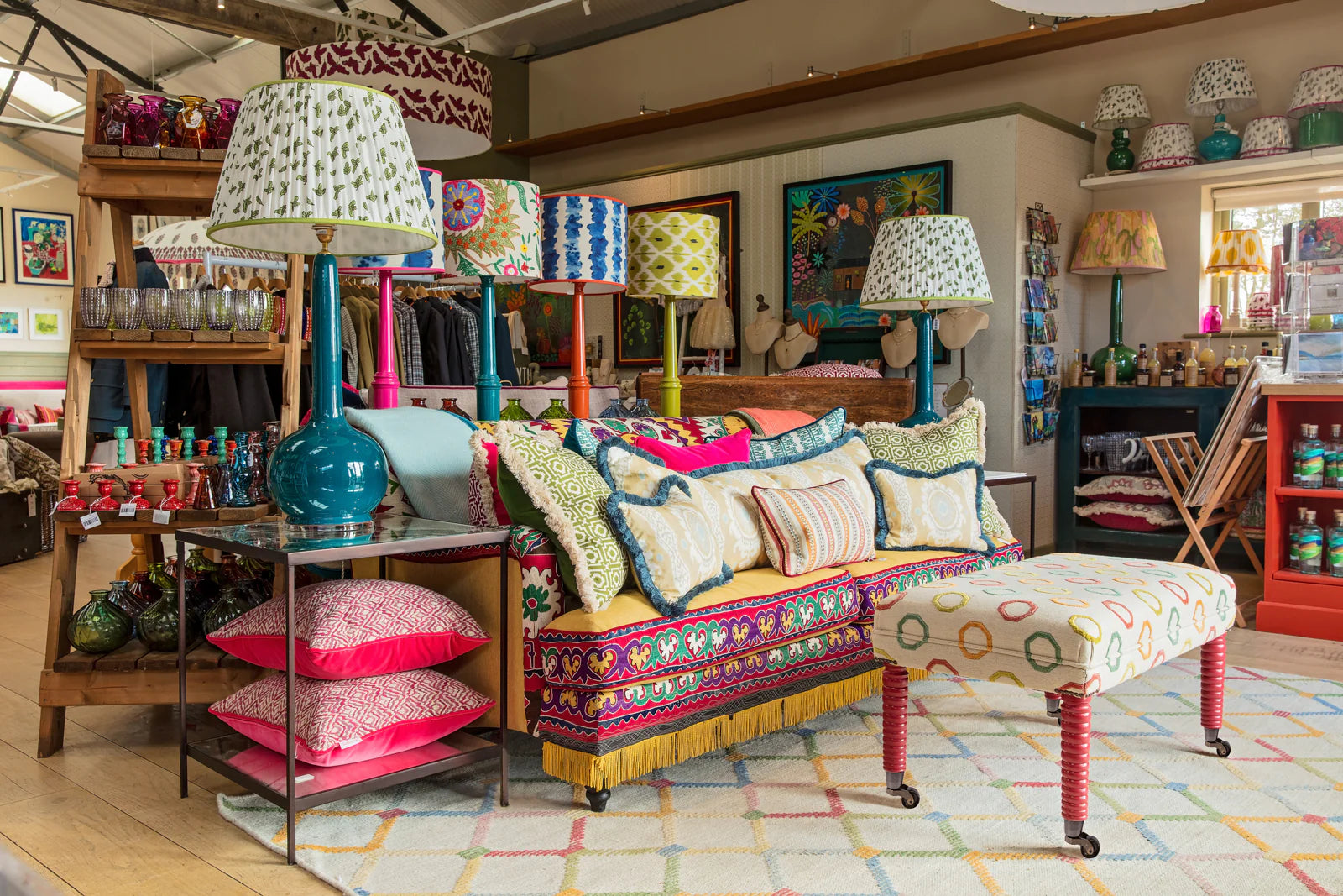 Colorful interior with a sofa, lamps, and decorative items in a store setting.