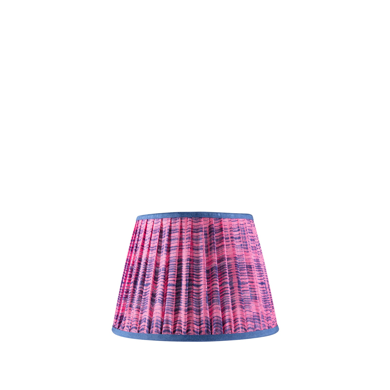 A pink and blue patterned lampshade with a gathered trim, handcrafted from Indian saree fabric.
