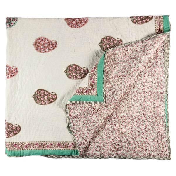 Large green and pink patterned bedspread.